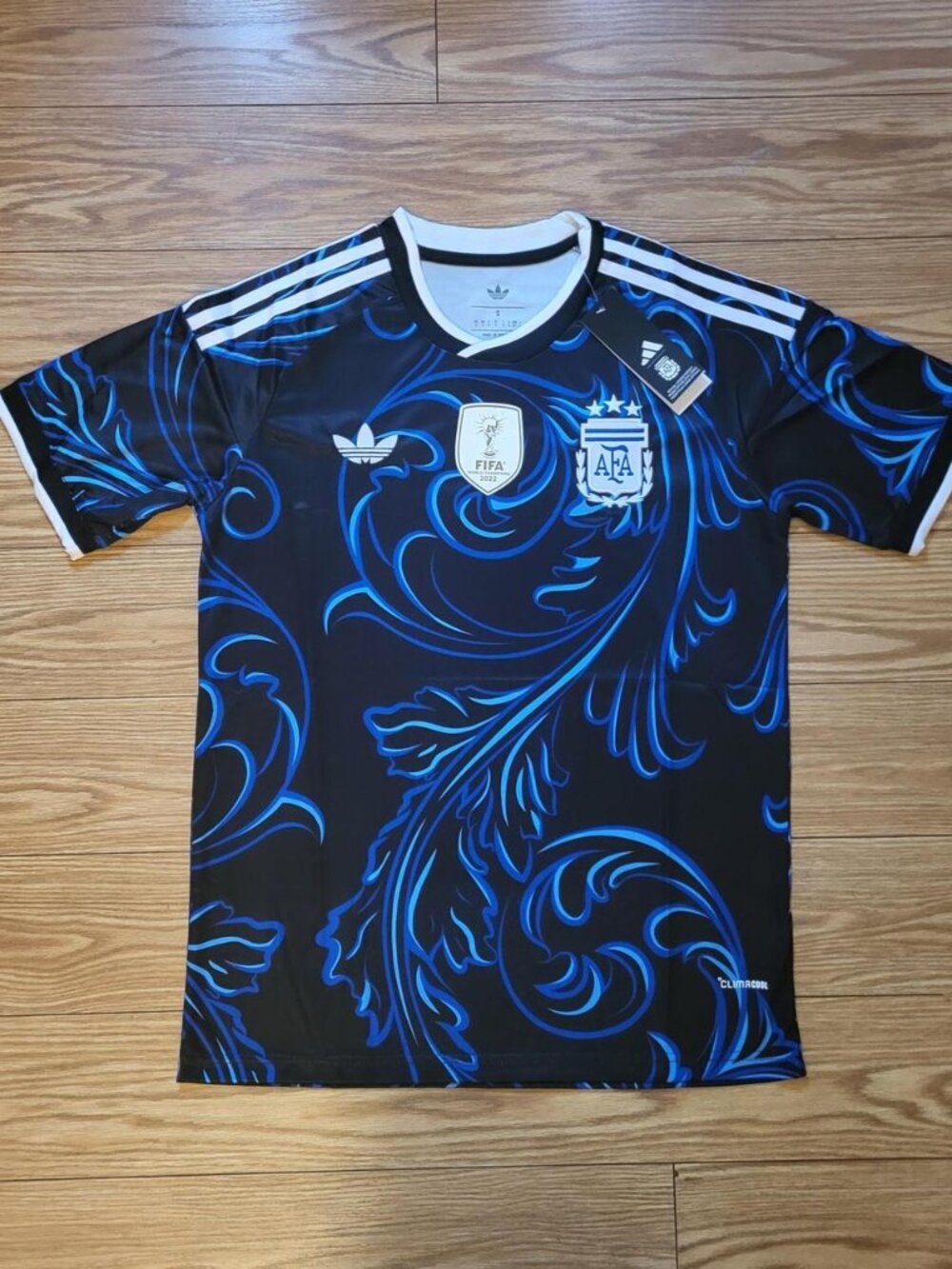 Adidas Argentina 2022 World Cup jersey with blue ornate swirls on black